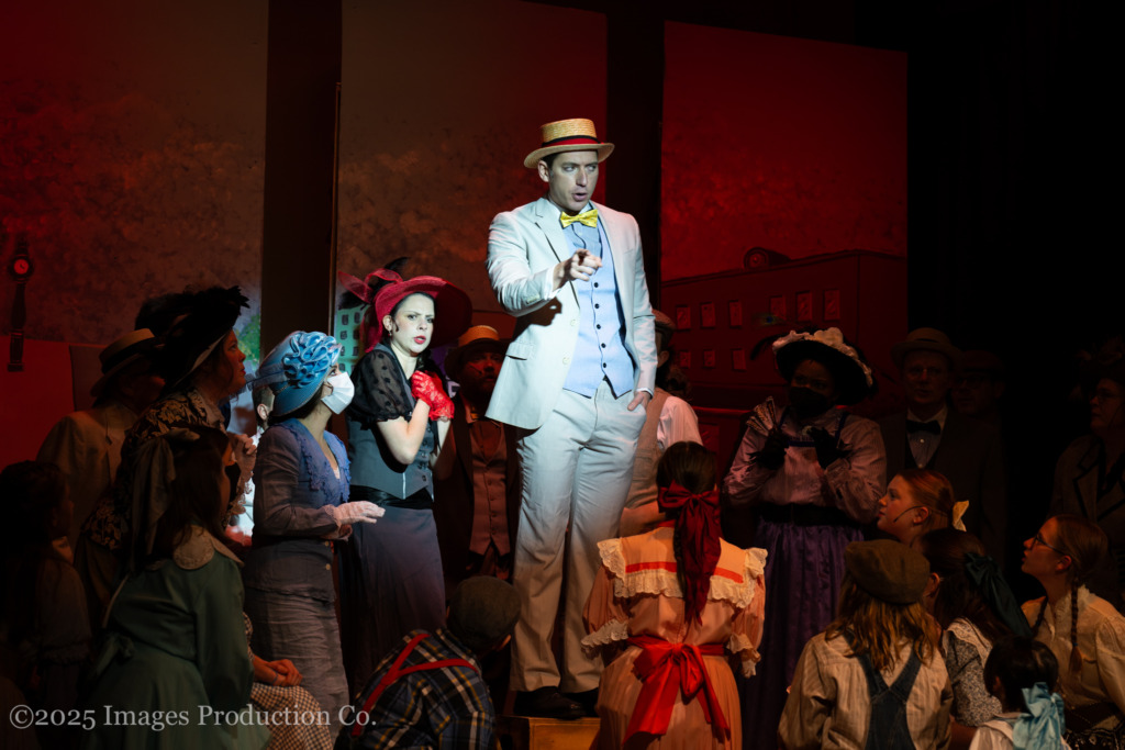 Adam Goldsmith (center) as Harold Hill and the cast of The Music Man at Third Wall Productions 📷 Images Production Co.