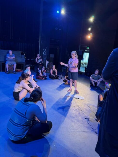 Bambi Johnson (standing center) directing a rehearsal of Cats at Cockpit in Court