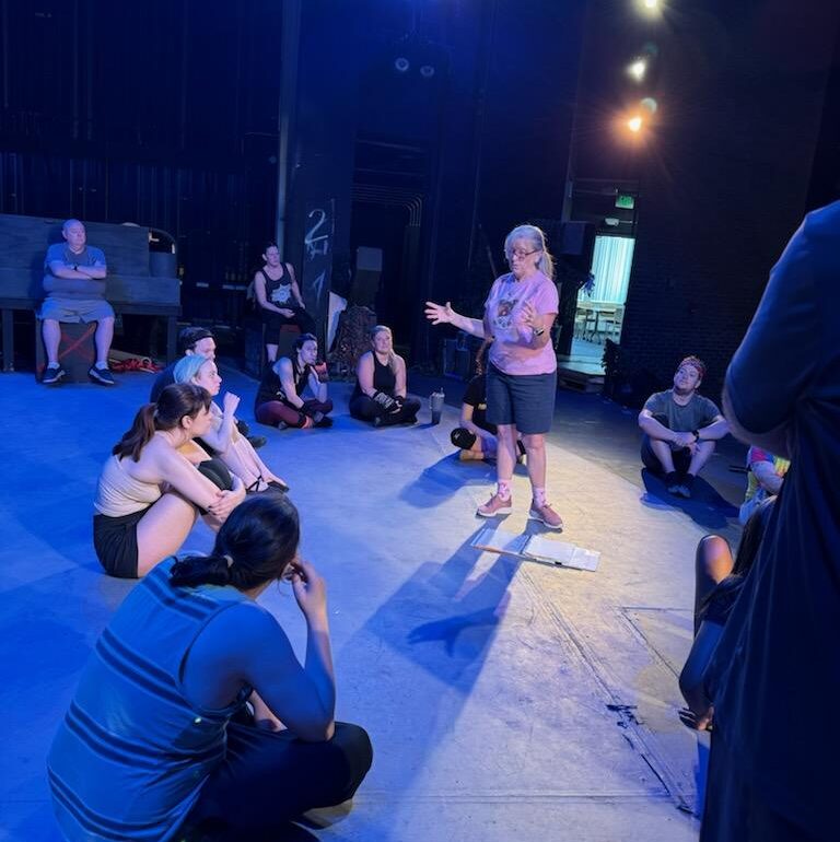 Bambi Johnson (standing center) directing a rehearsal of Cats at Cockpit in Court