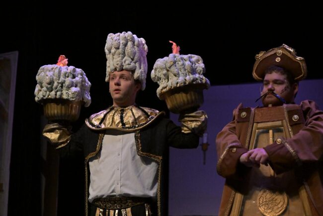 Will Brown (left) as Lumiere and Andrew Lyon (right) as Cogsworth in Beauty & The Beast at Small Town Stars Theatre Company 📷 Mort Shuman