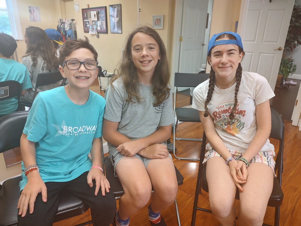 Colton Roberts (left) with Brady Katzenberger (center) and Mara Weeks (right) sitting for this interview at a School of Rock rehearsal