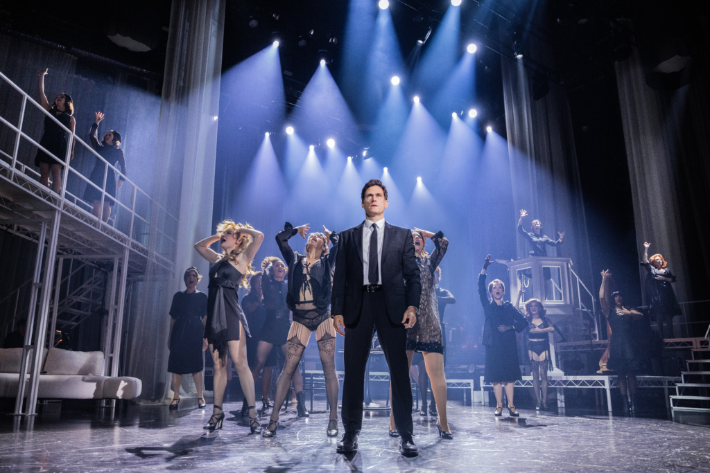 Steven Pasquale (center) as Guido and company in Nine at The Kennedy Center 📷 Evan Zimmerman