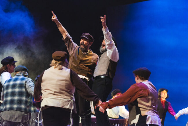 James Gilbert (left) as Tevye and Sam Brooks (right) as Lazar Wolf and the ensemble in Fiddler on the Roof 📷 Matthew Peterson