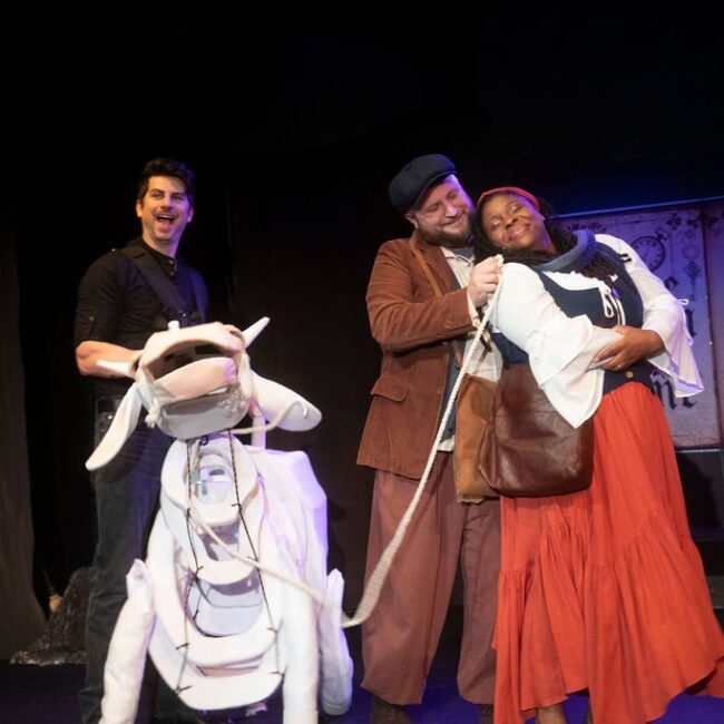 Matthew Lindsay Payne (left) as Milky White with Andrew Worthington (center) as the Baker and Alana Simone (right) as the Baker's Wife in Into The Woods at the Vagabond Players 📷 Shealyn Jae Photography