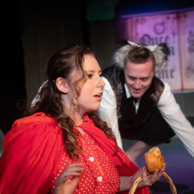 Alissa Suser (left) as Little Red Ridinghood and Jonathan Lightner (right) as The Wolf in Into The Woods at the Vagabond Players 📷 Shealyn Jae Photography