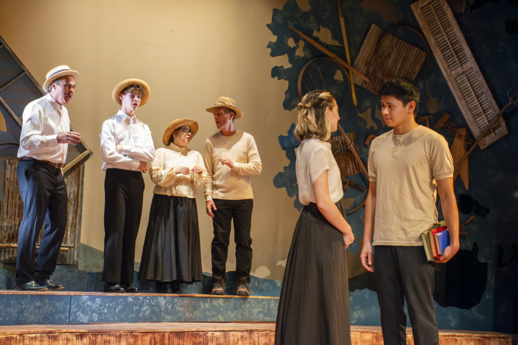 (L to R; background in the Quartet) Greg Guyton, Teagle Walker, Cat Bustos, and Paul Norfolk with Julia L. Williams (front left) as Emily Webb and Marlo Lacson (front right) as George Gibbs in Our Town at Manor Mill Playhouse 📷 Zoe Leonard 