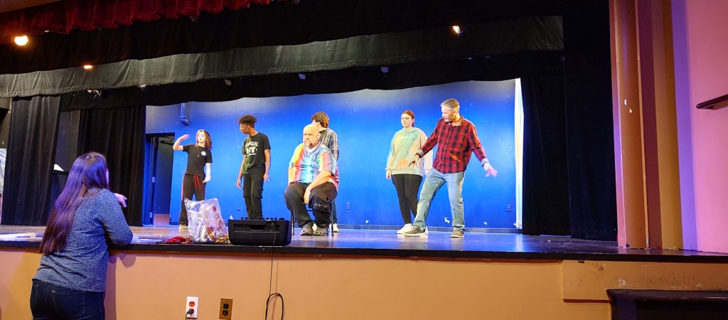 Sarah O'Hara (back facing us) directing a rehearsal of Tidewater Players' A Christmas Carol 